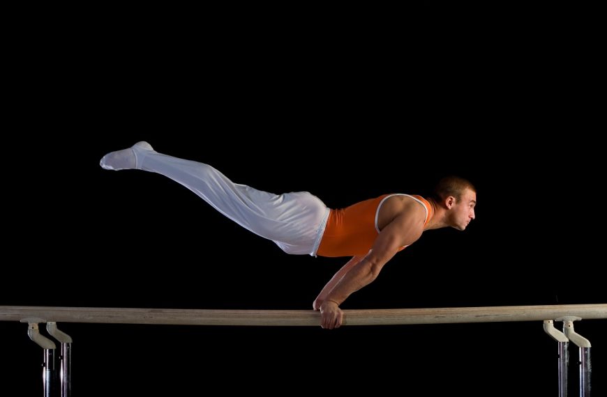 male gymnast performing on parallel bars